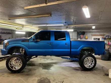 Lifted Ford F-250 inside the Midwest Custom Trucks shop