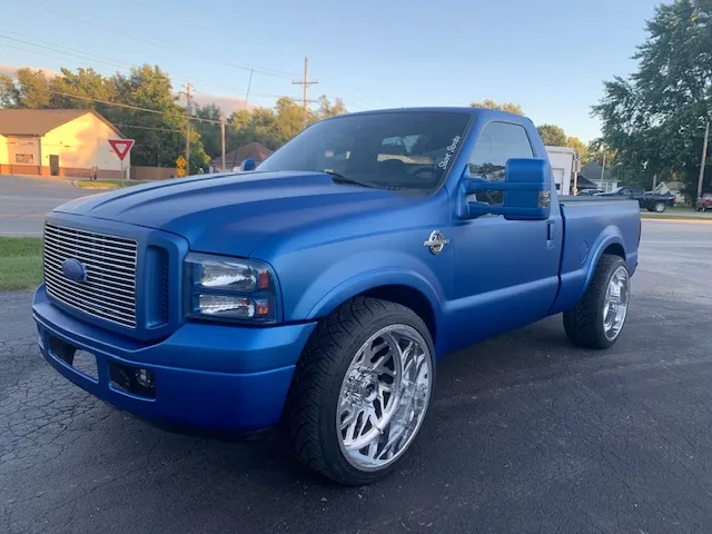 Matte blue Ford Super Duty single-cab on polished forged wheels