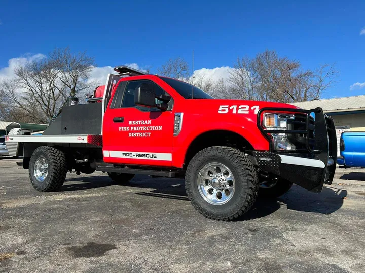 Custom flatbed truck build with grille guard and front bumper by Midwest Custom Trucks