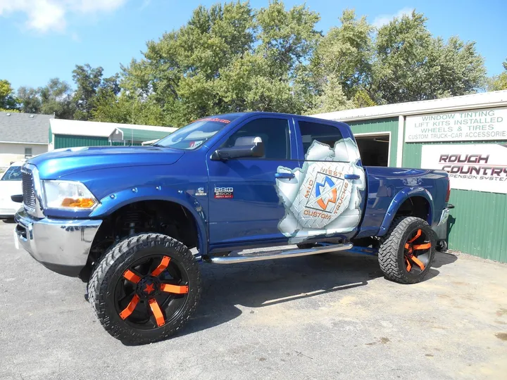 Custom Ram with running boards and side steps outside the Midwest Custom Trucks shop