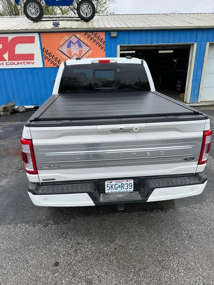 Retractable tonneau bed cover installed on a Ford F-150 at the Midwest Custom Trucks shop