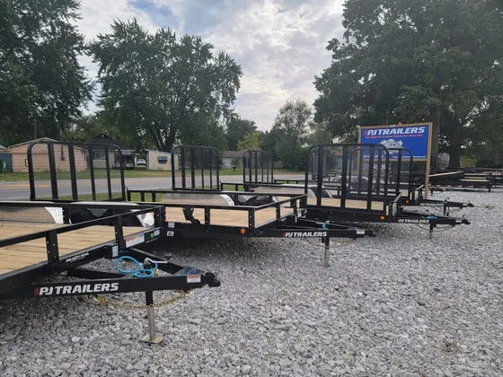 PJ's Trailers lot with trailers and signage at Midwest Custom Trucks