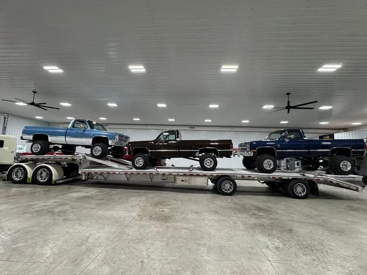 Custom square-body Chevy truck builds staged inside the Midwest Custom Trucks shop in Moberly